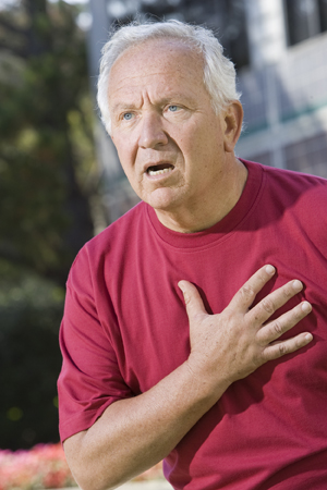 Man holding hand to chest and looking distressed.