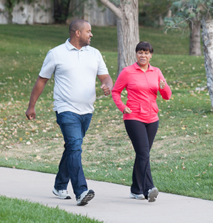 Man and woman walking in park.